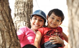 Children in scout camp playing on tree